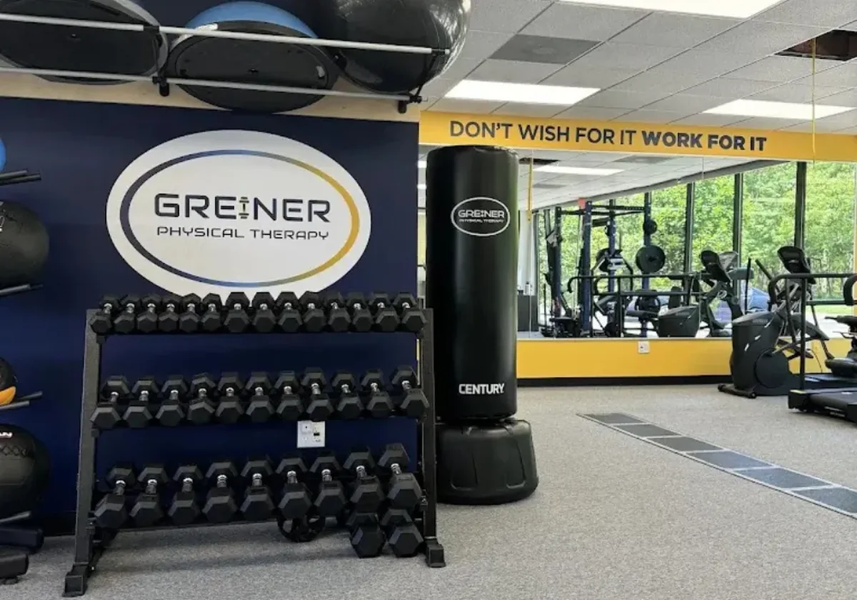 Dumbbell wall and heavy bag with a work for it wall graphic