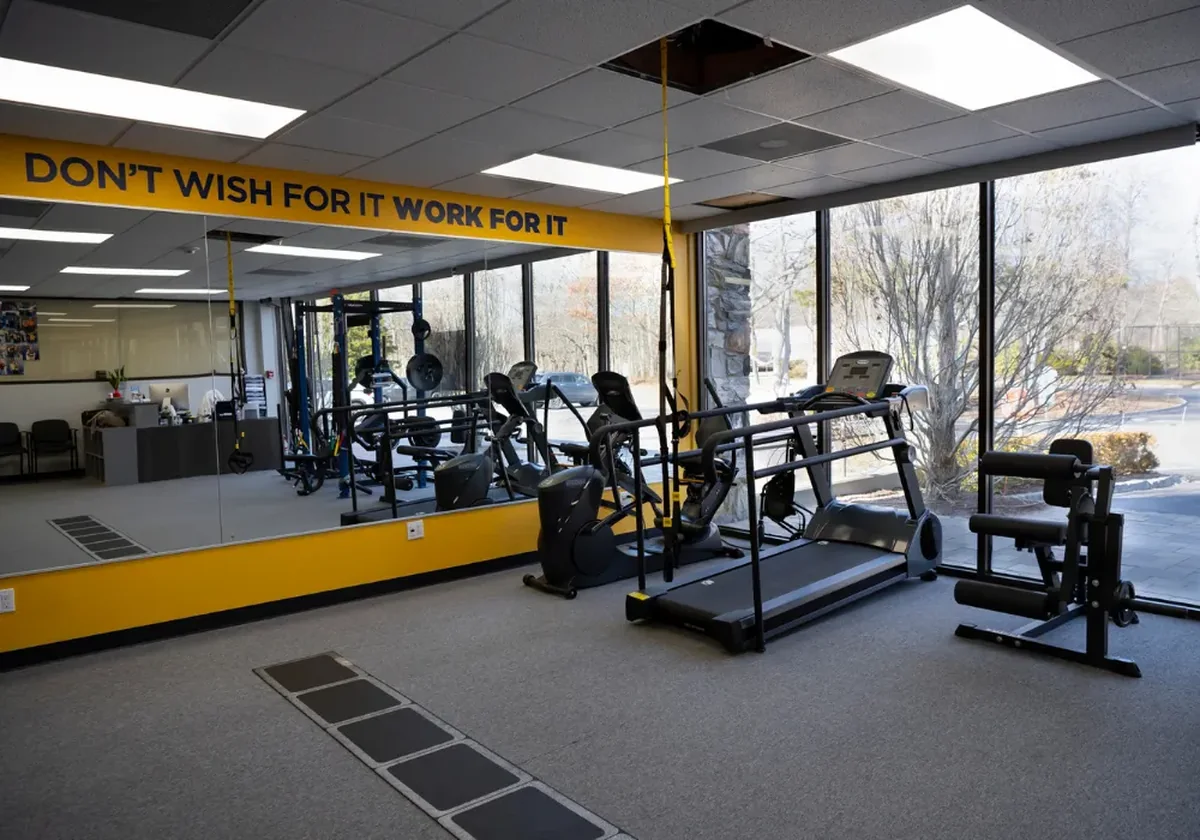 Open gym floor with a TRX suspension rig