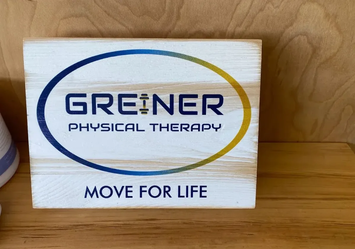 Wooden Greiner Physical Therapy sign on the wall of the Speonk clinic